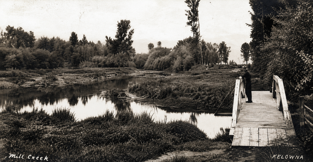 Historic photograph of the Abbott Street footbridge over Mill Creek in Kelowna around 1907